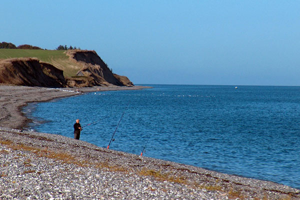 Lystfisker på stranden